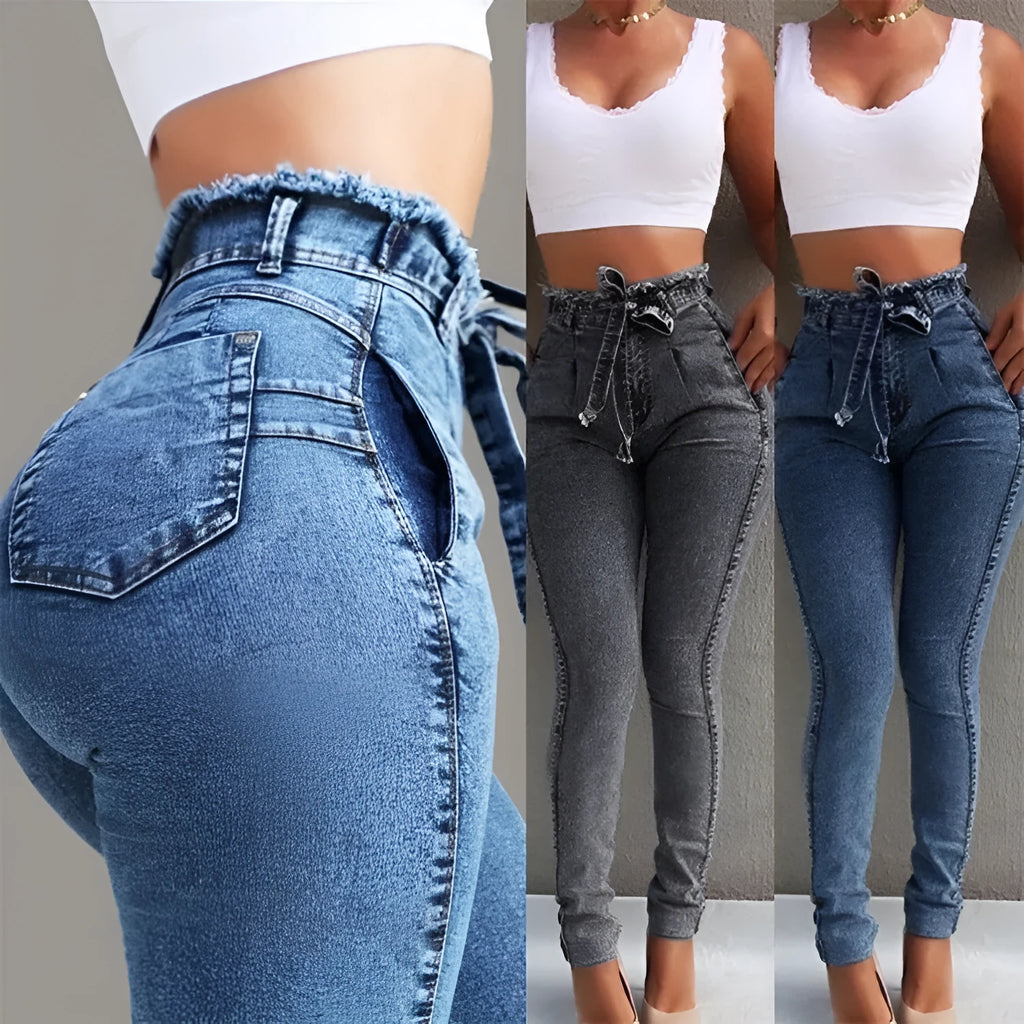Men's dark blue jeans with frayed fringed hems laid flat on a surface.