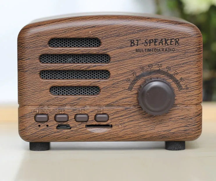 Compact vintage wood finish Bluetooth speaker in black, pink, or wood grain colour