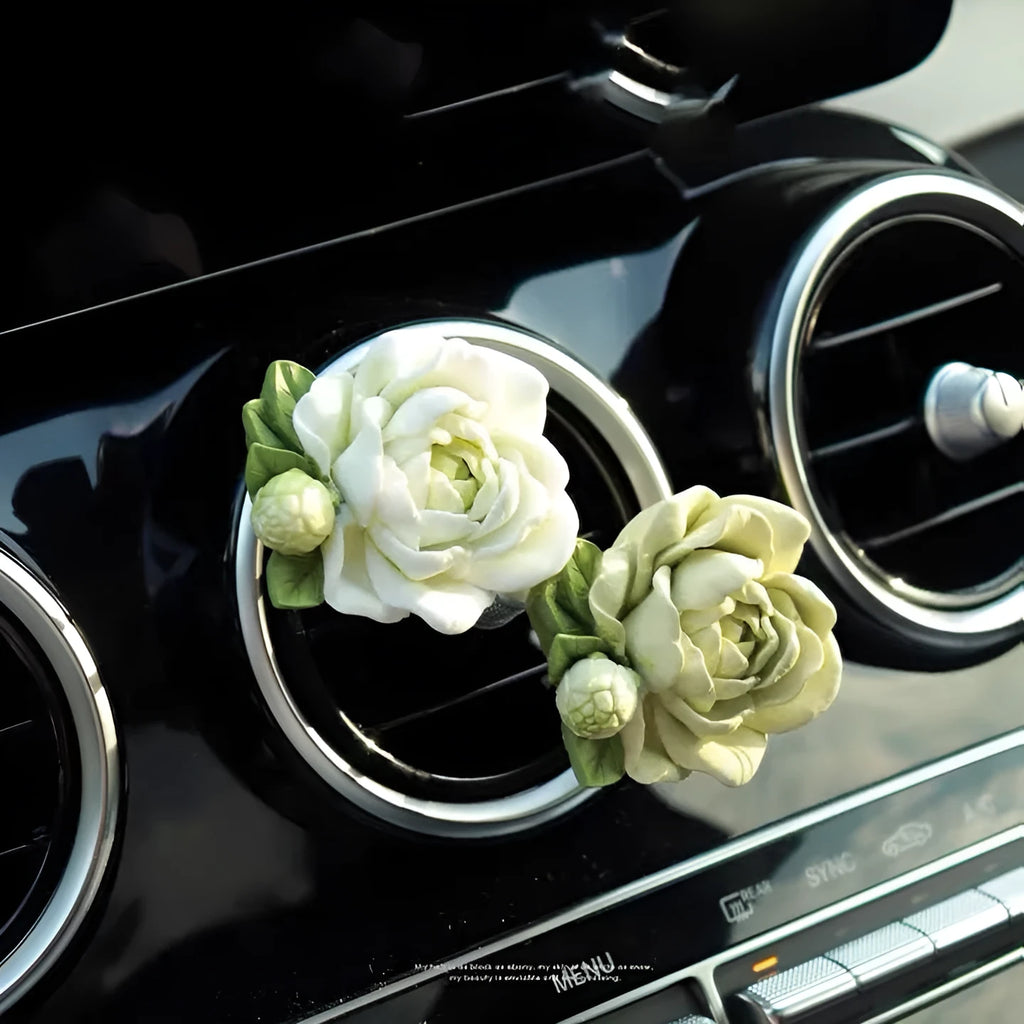 Jasmine solid car perfume gypsum tablet clipped to a car air vent.