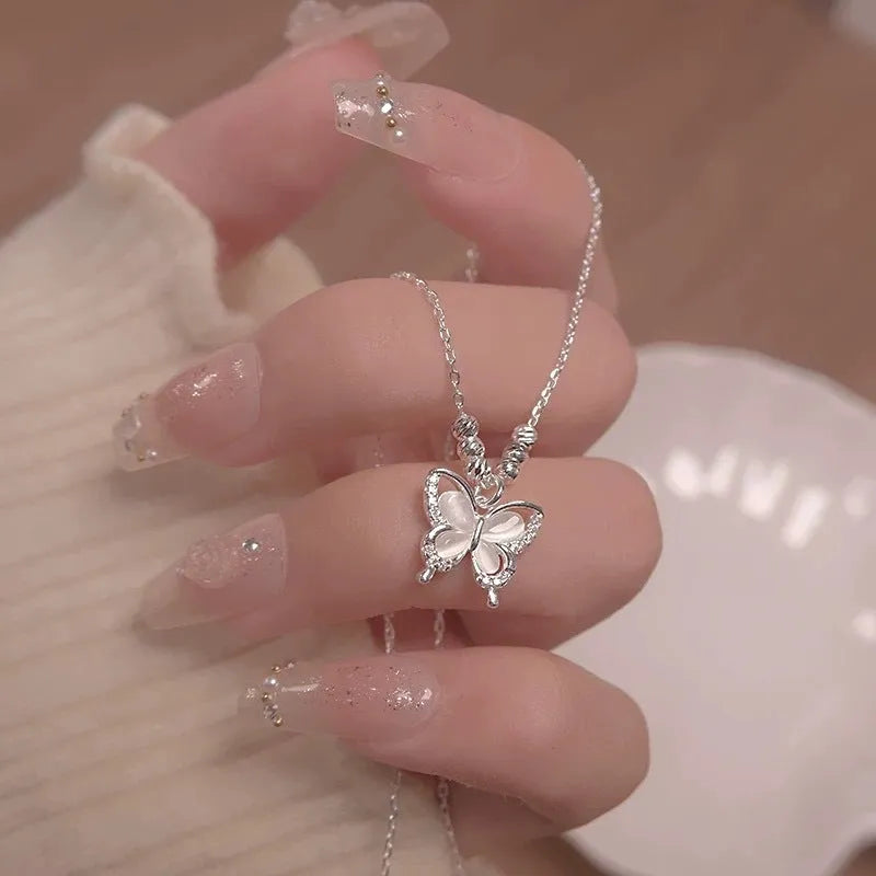 Square-set opal butterfly pendant on a cross chain, sterling silver women's adjustable necklace.