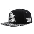 Cotton baseball hat with front letter embroidery in black colour, showing adjustable strap and dome crown.