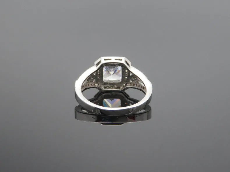 Women's platinum-colour hollow geometric zircon ring on a copper band, shown in size 7.