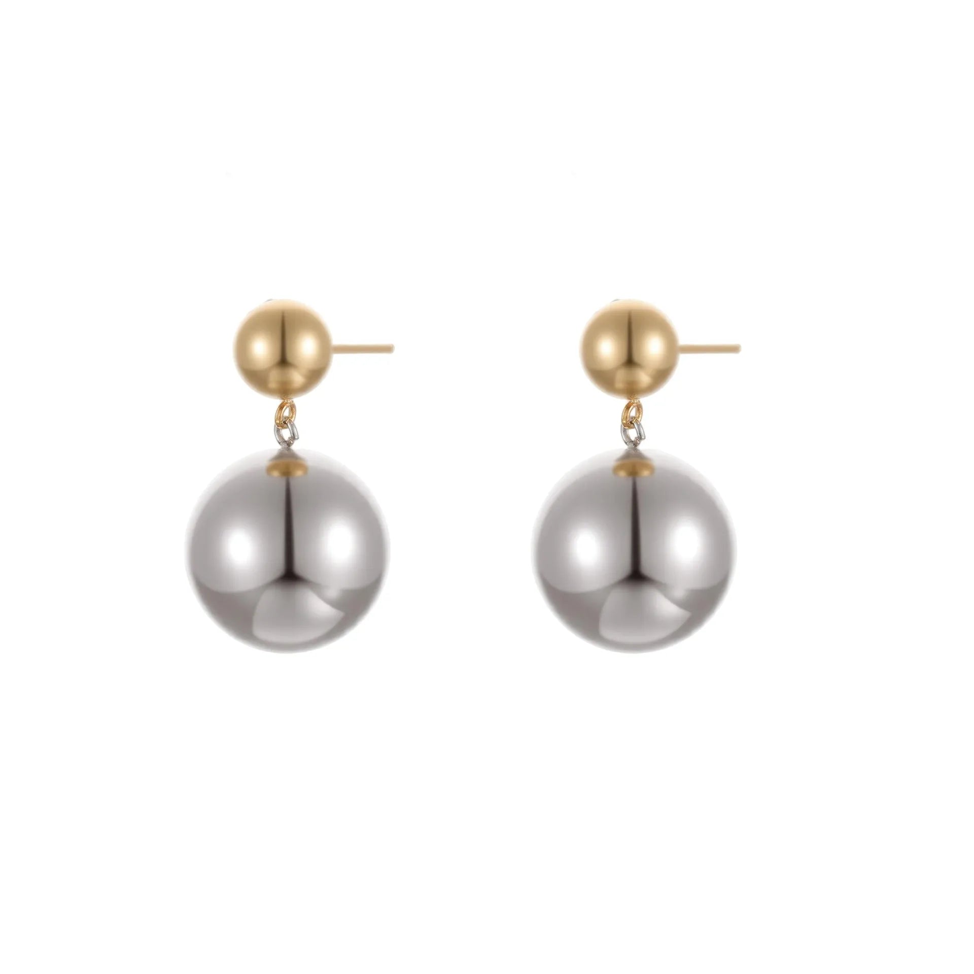 Pair of round bead stud earrings with gold plating and colour-block design on a woman's earlobe.