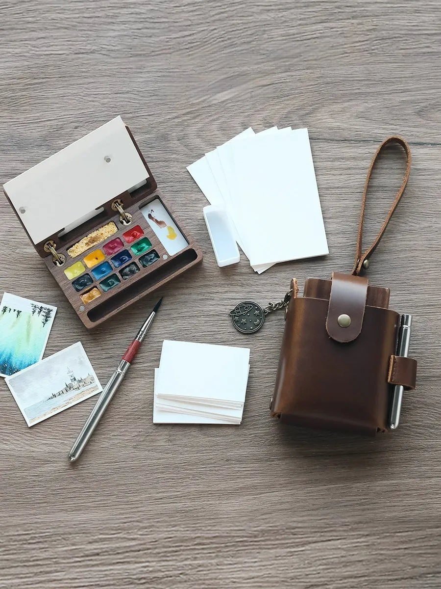 Miniature walnut wood watercolour box with brass fittings and professional paint tubes in leather case
