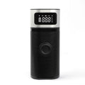 Black portable wireless smart vehicle air pump with a display, inflation tube, and multiple nozzles on a dark background.
