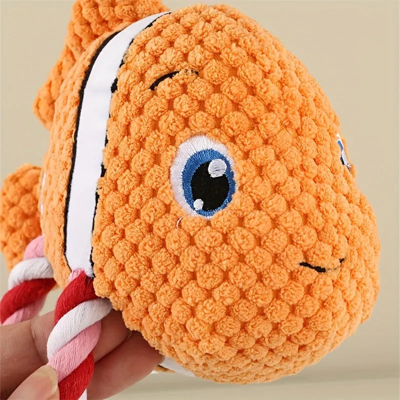Grey turtle-shaped knot toy for dogs with a built-in squeaker on a plain background