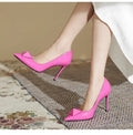 Pink pointed toe stiletto high heels with a buckle detail on the patent leather upper.