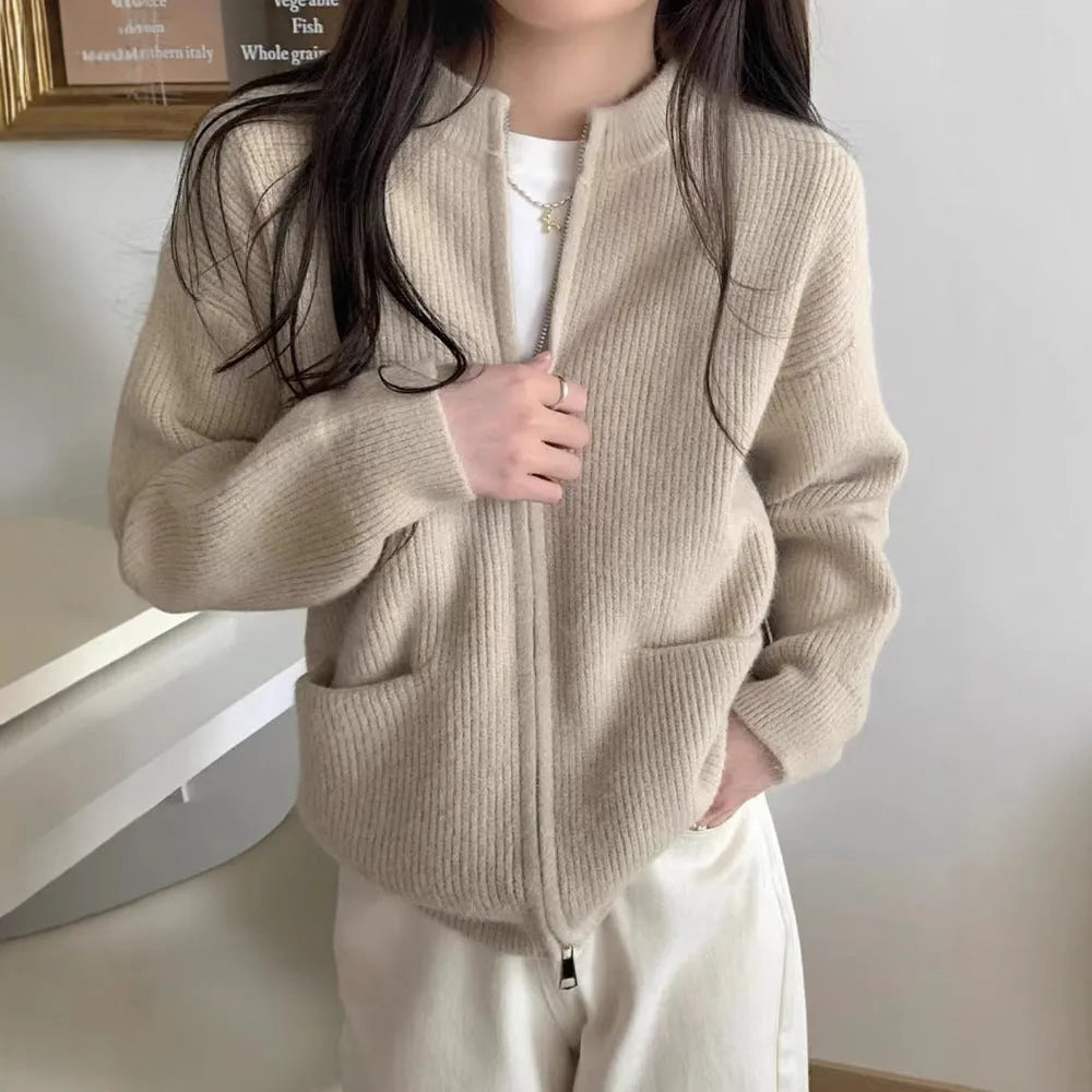 Beige women's soft viscose sweater coat cardigan with long sleeves on a hanger.