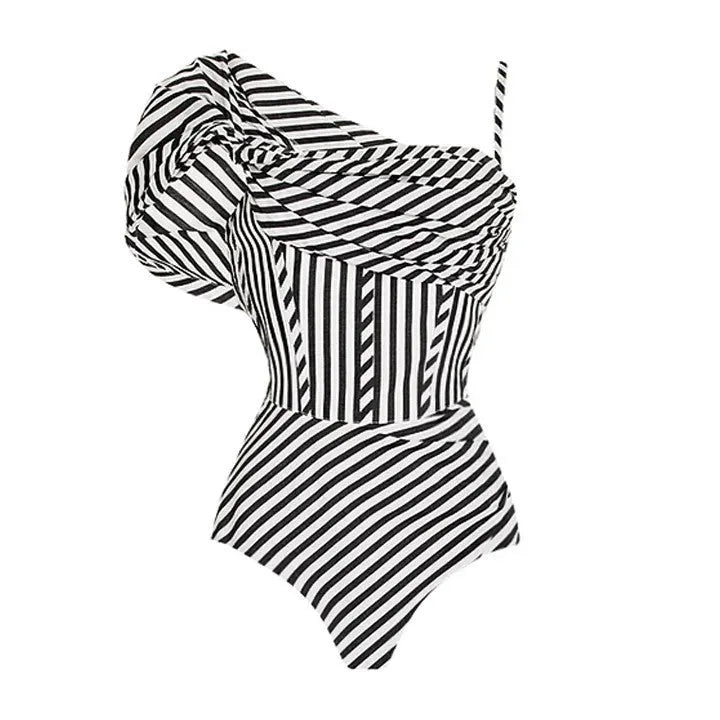 Women's black and white striped one-piece swimsuit with a ruffled skirt.
