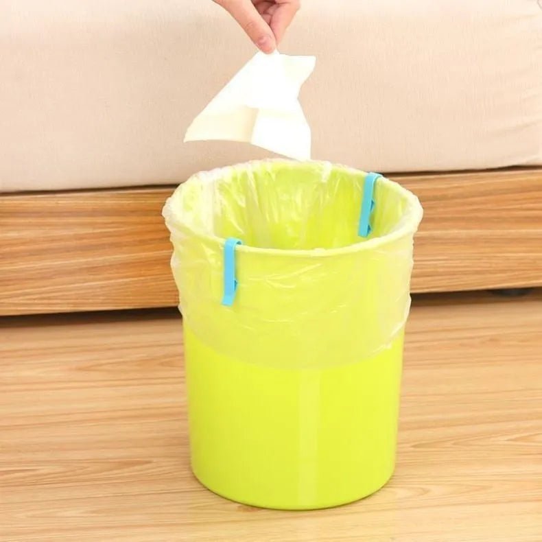 A white polypropylene plastic clip for holding bin bags onto the side of a rubbish bin.