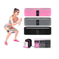 Set of three fabric resistance bands in lake blue, pink, and purple with a mesh storage bag