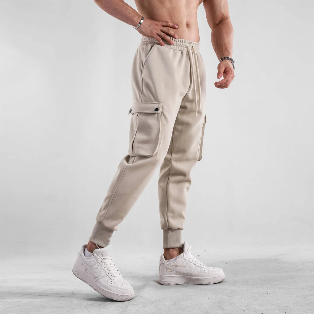 Men's loose cotton sports trousers with ankle-tied cuffs in solid colours
