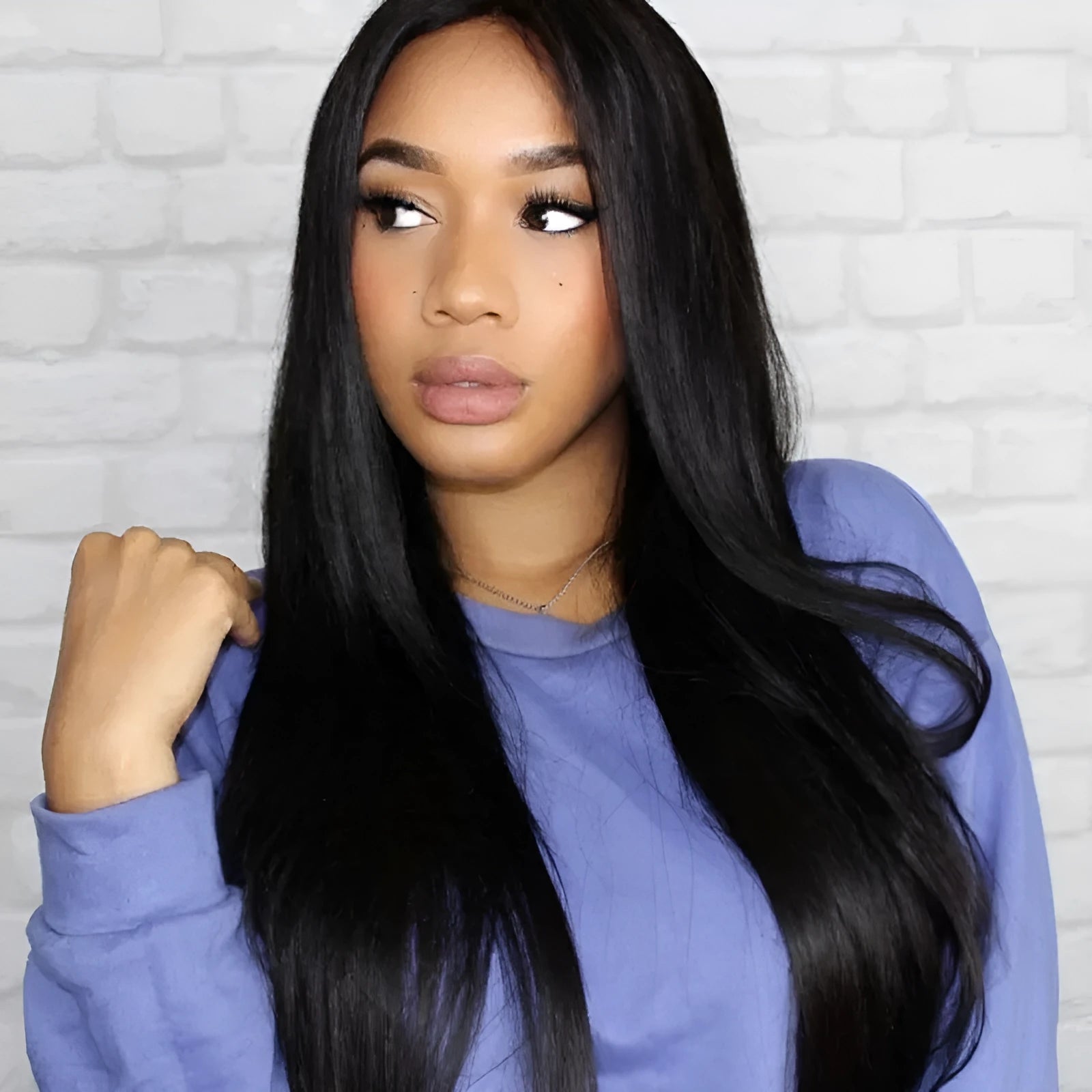 Long black straight hair wig with centre-parted bangs on a model