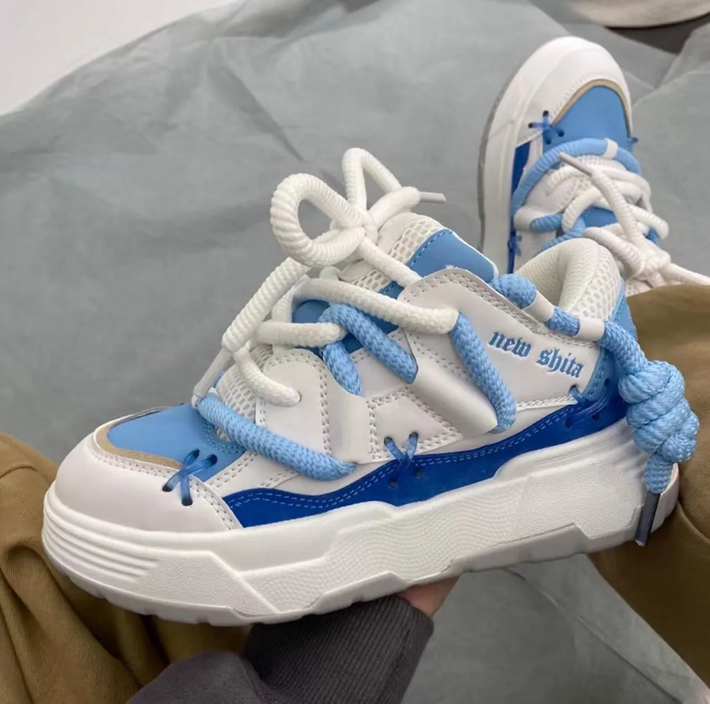 Women's grey retro chunky sneakers with thick rubber sole and high heel on a plain background