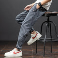 Man wearing grey-blue straight leg cargo jeans with micro elasticity and cargo pockets.
