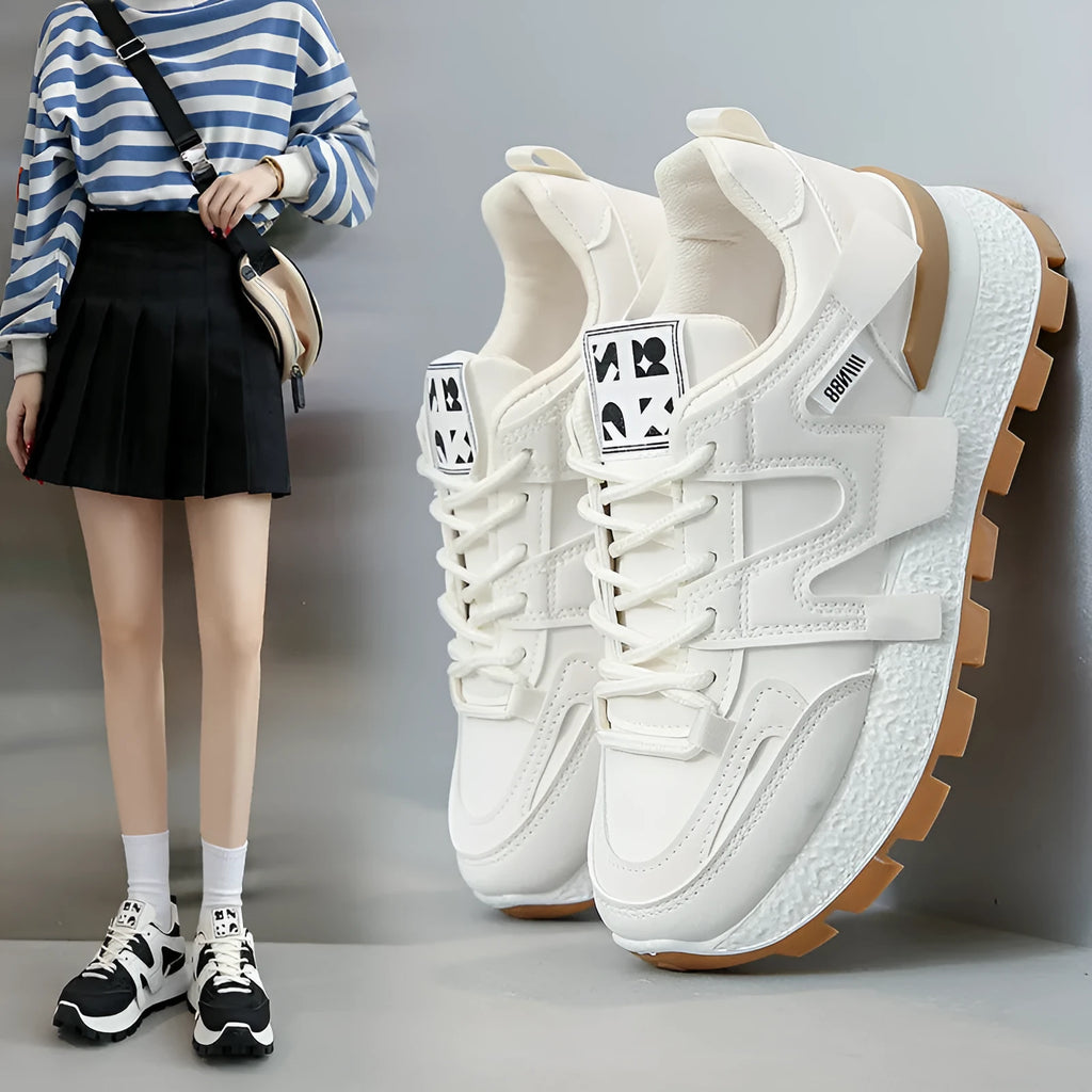 Artificial PU low top running sneakers in white and black colours with front lace-up design