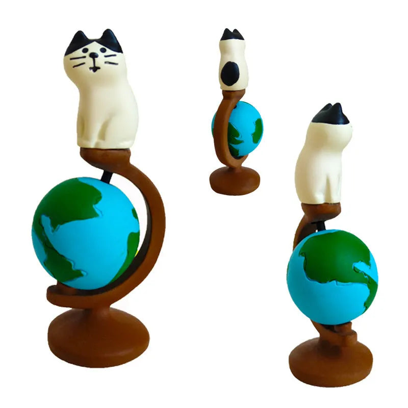 Cartoon style Statue of Liberty cat resin figurine craft on display surface.