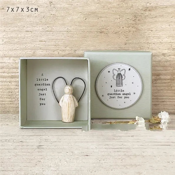 Boxed resin and plastic guardian angel figurine ornament in a modern cartoon style.
