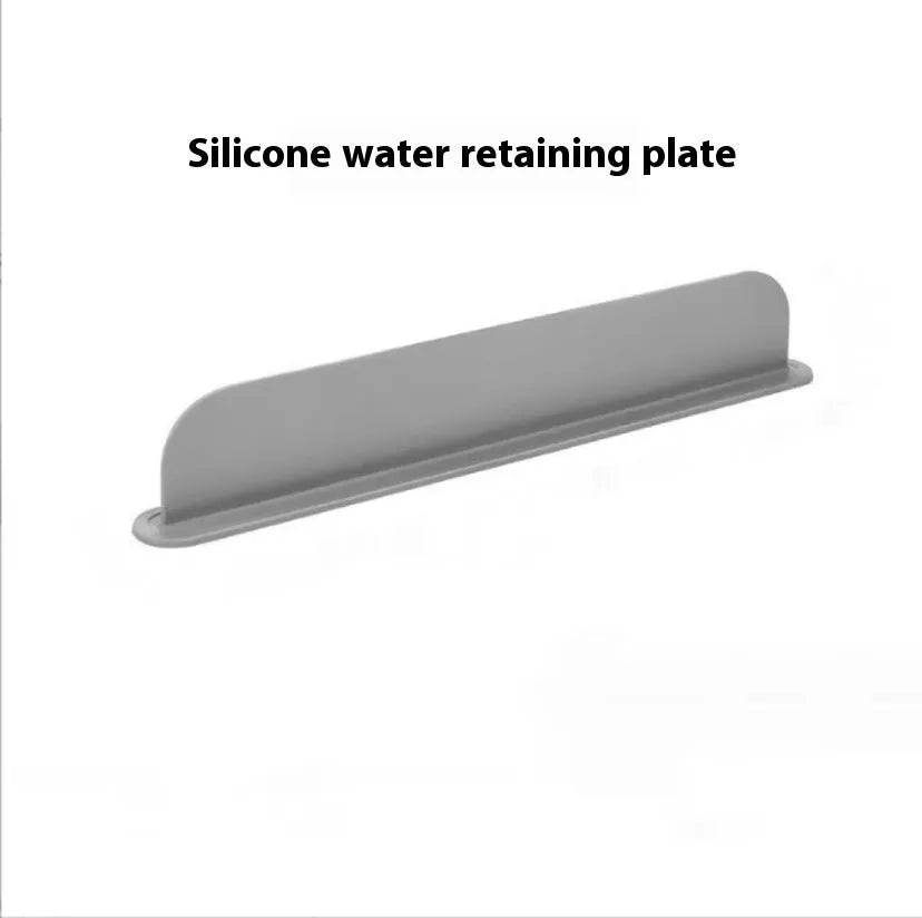 Grey silicone sink water blocking plate placed behind a kitchen tap