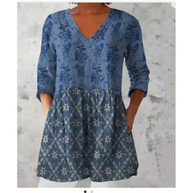 Women's printed loose wave dress with 3/4 sleeves and a wide waist on a hanger.