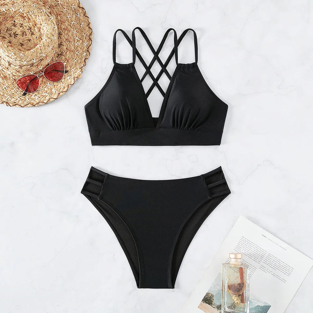 Women's black halter V-neck bikini top and matching split-style swim shorts.
