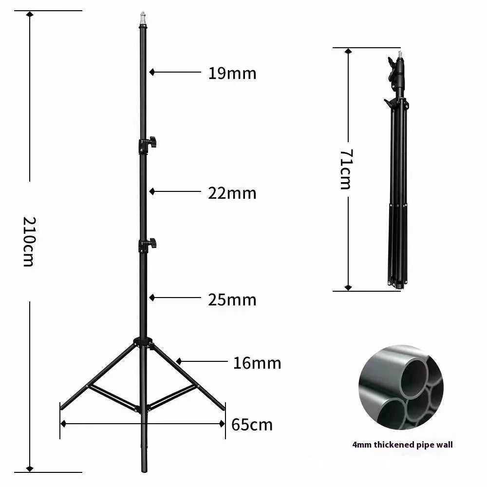 Tall black floor tripod stand holding a mobile phone extended to its full height on a wooden floor.