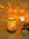 Compact acrylic rotating water ripple night light on a solid wood base with USB cable.