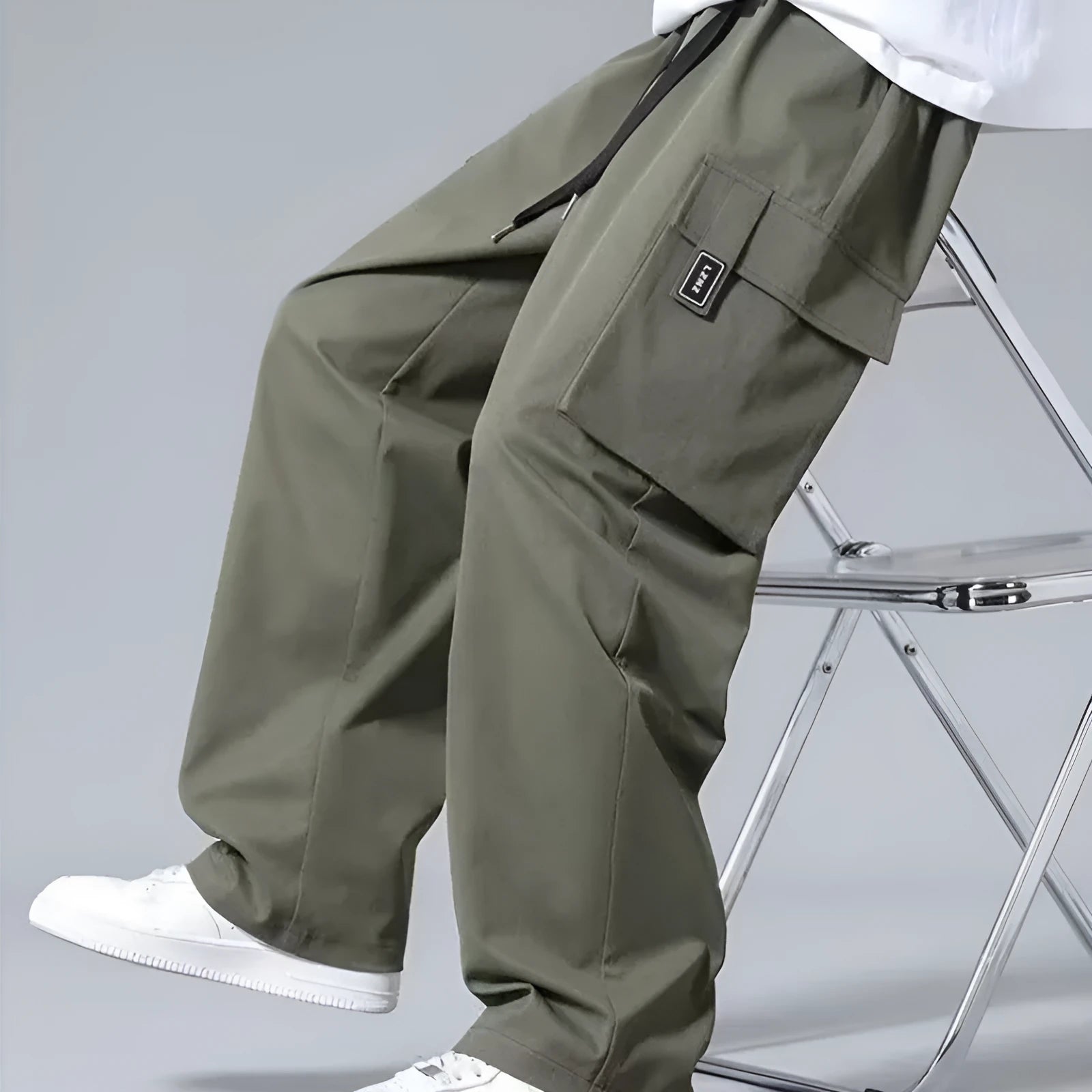 Boys' straight leg cargo pants in army green with large pockets and a drawstring waistband.