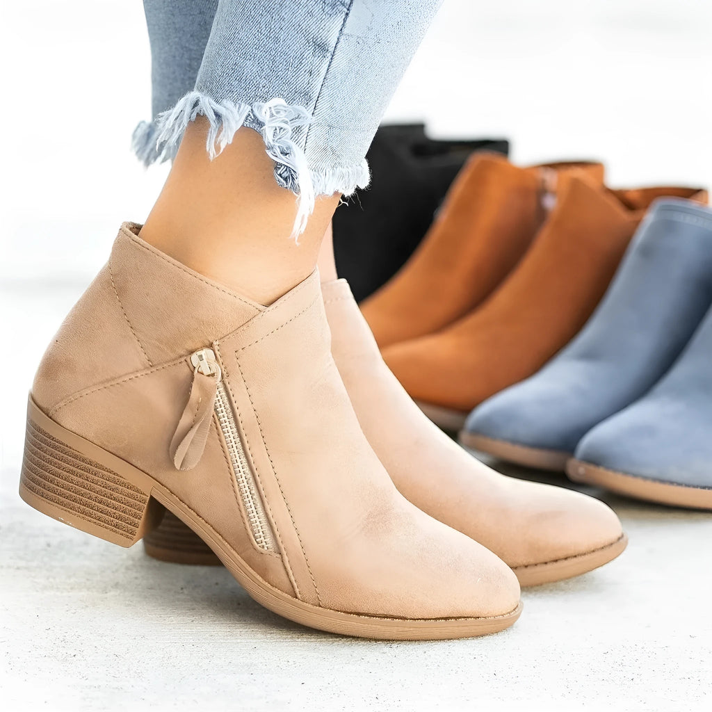 Women's ankle boots in suede with a side zip and chunky heel, shown in beige colour.