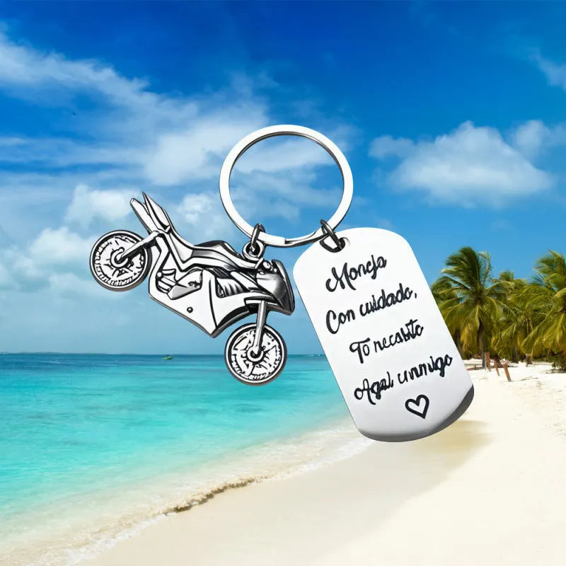 Stainless steel motorcycle keychain with inspirational charm on a flannel bag.