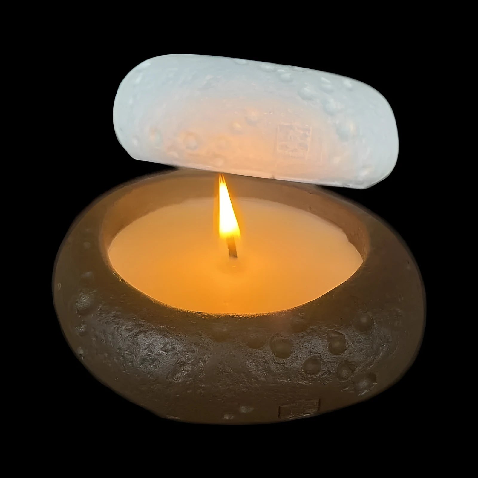 Fair-faced concrete candlestick ornament in white colour on a flat surface