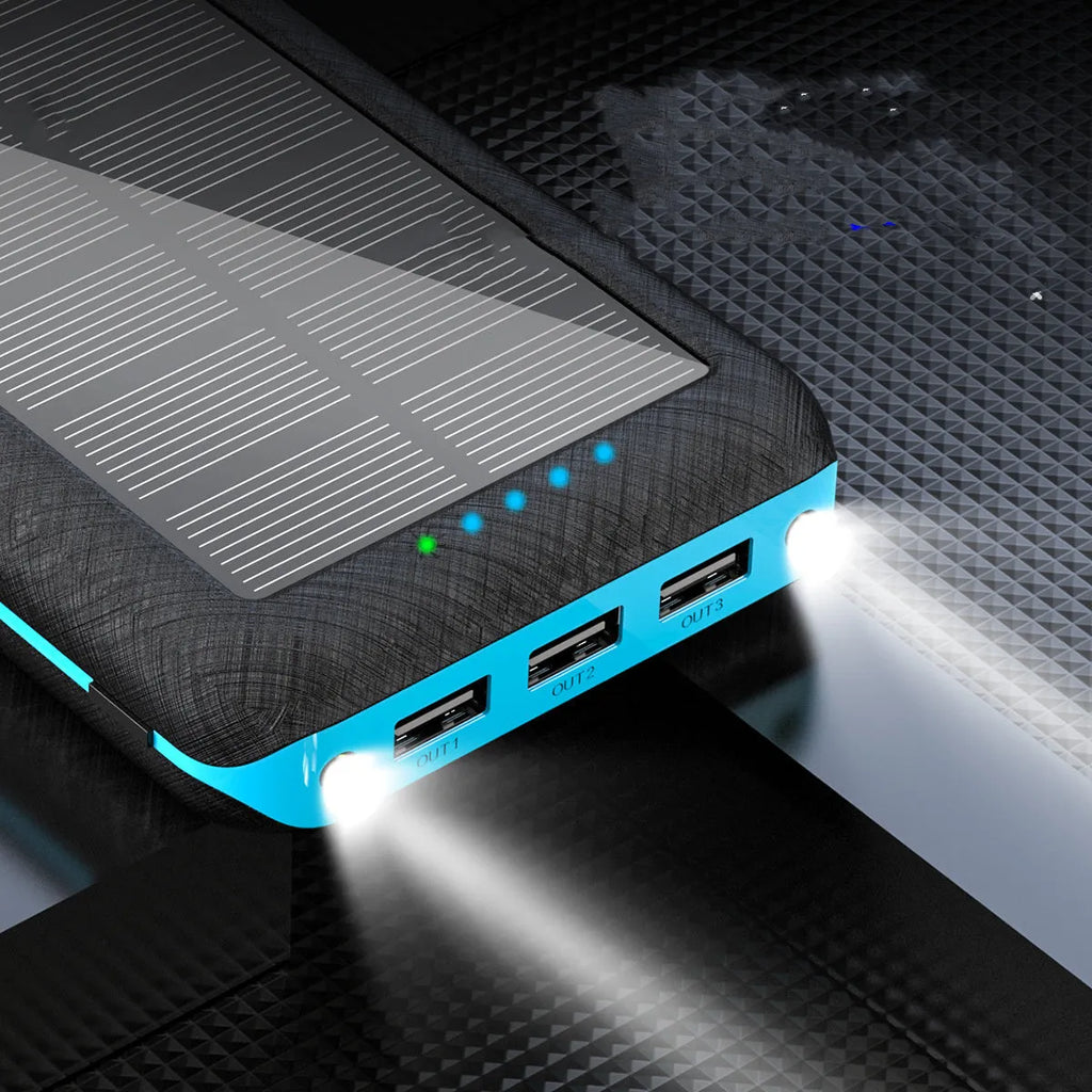 Black portable power bank with Qi wireless charging pad, three USB ports, and an LED flashlight on the front.