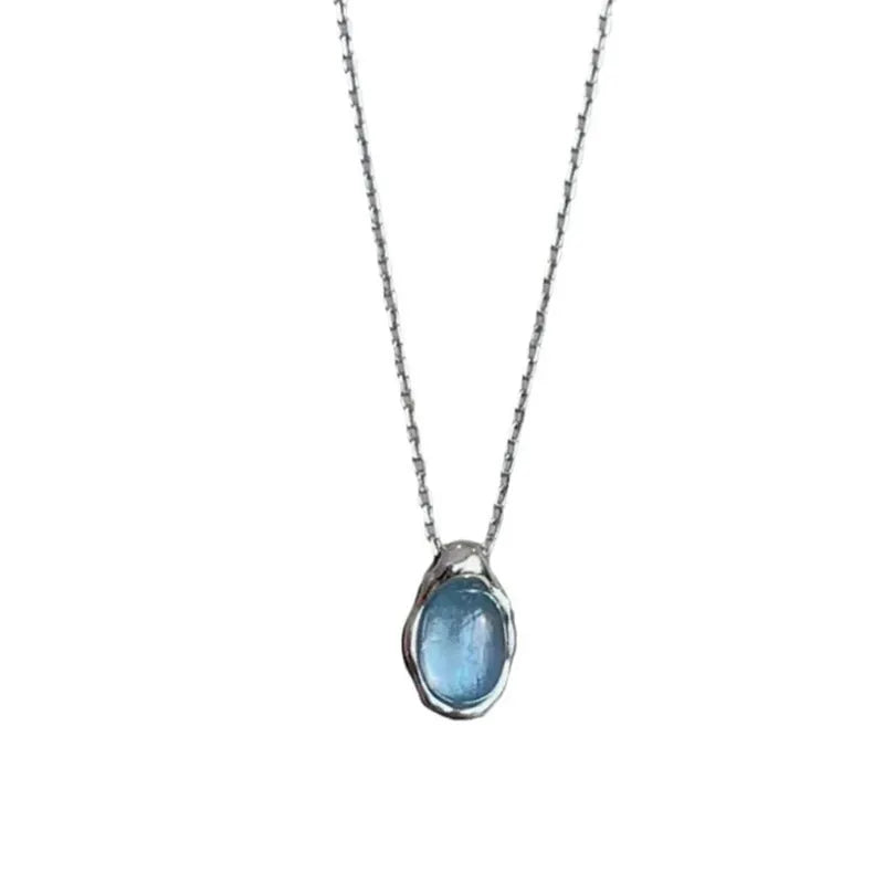 Navy blue water drop pendant necklace with adjustable chain on neutral background