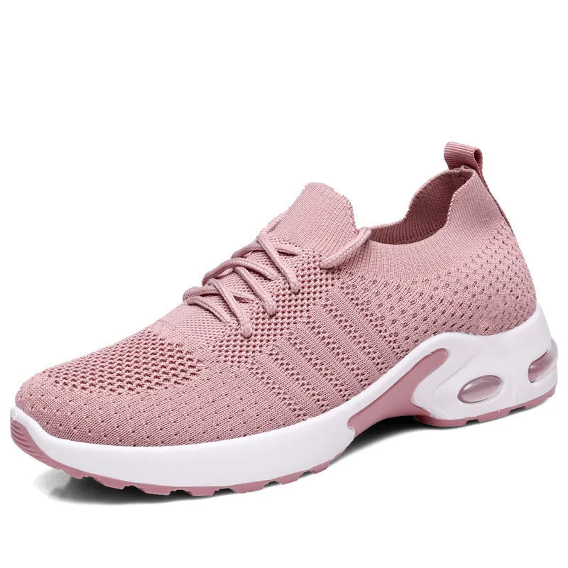 Women's black mesh sneakers with a soft sole and round toe, shown with lace-up front closure.