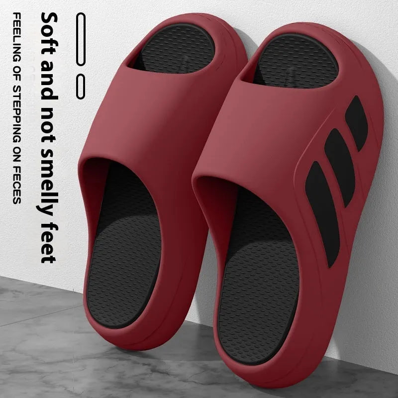 Men's and women's brown EVA platform slippers with a letter detail on the upper, shown on a white background.