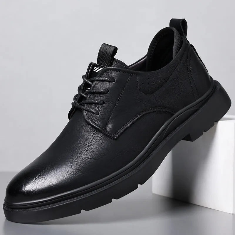 Men's black leather shoes with visible stitching on a two-layer cowhide upper and a rubber sole.