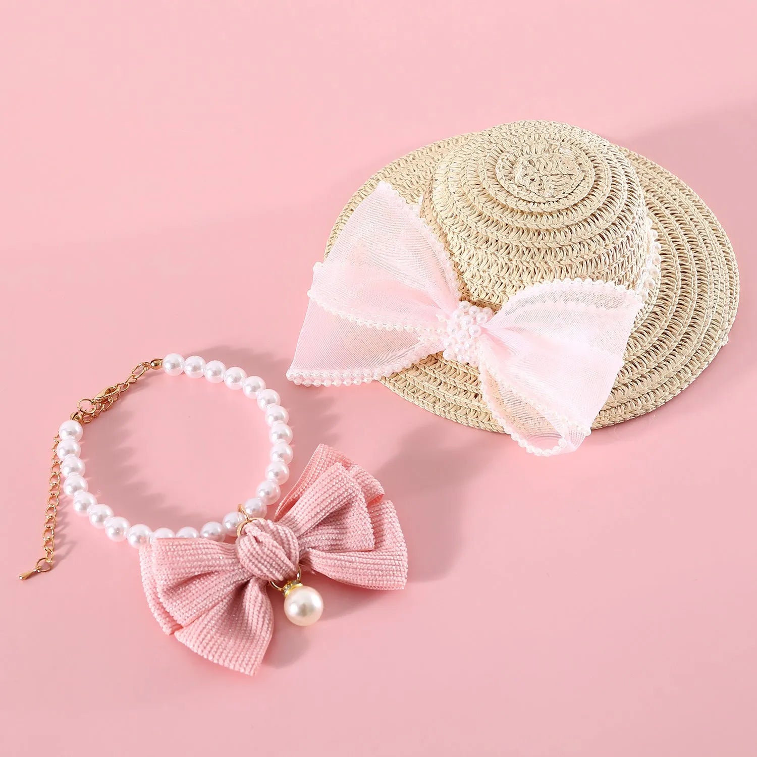 Cat wearing a woven straw hat with a pearl butterfly bow on its head.