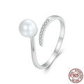 Women's adjustable sterling silver ring with a natural shell pearl on an opening loop band.