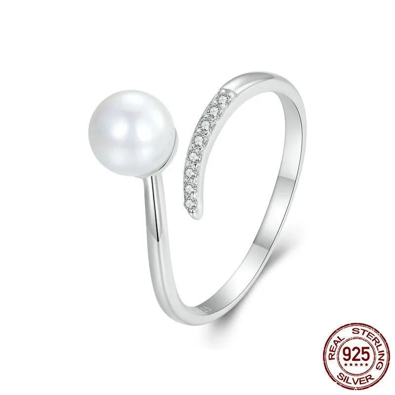 Women's adjustable sterling silver ring with a natural shell pearl on an opening loop band.