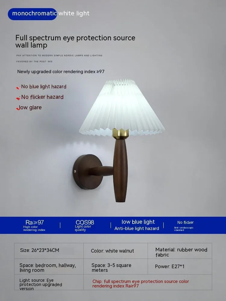Retro wooden wall lamp with fabric shade in walnut finish mounted beside a bed.