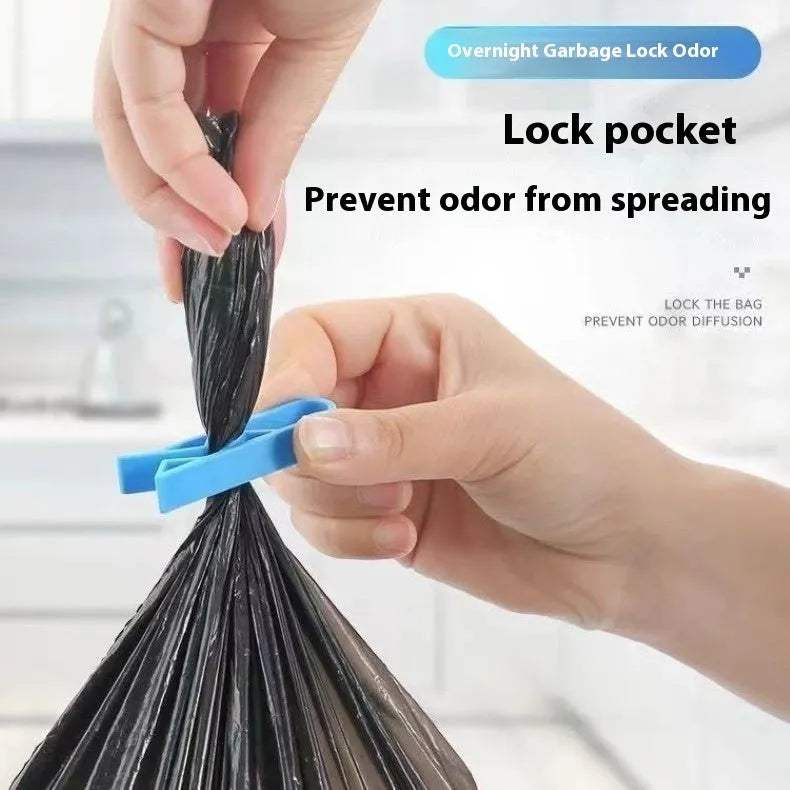 A white polypropylene plastic clip for holding bin bags onto the side of a rubbish bin.