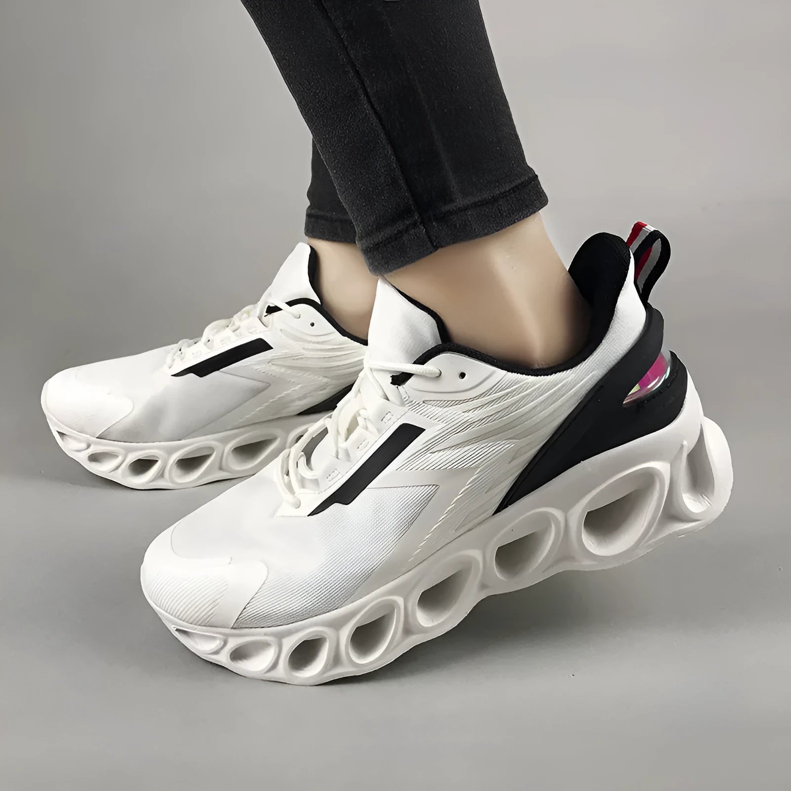 Men's low top casual shoes in black with mesh upper and white lace-up closure.