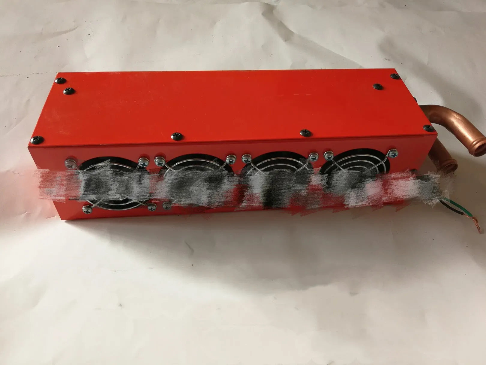 Metal auxiliary car heater with four-hole copper pipe connections for 12V and 24V vehicle installation.
