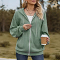 Green loose-fit women's hooded sweater coat with a front zipper and long sleeves on a hanger.