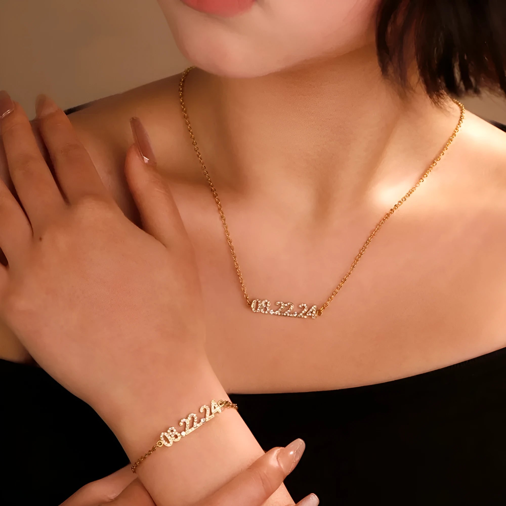 Stainless steel bracelet or necklace with diamond accents around digital numerals in gold, rose gold, or steel colour.