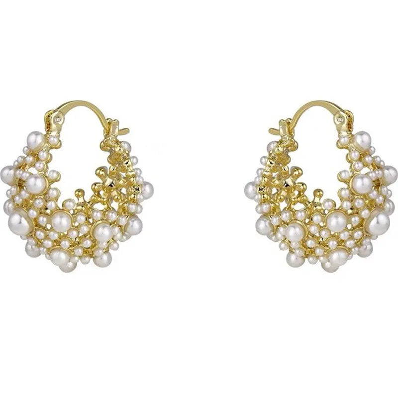 Gold-coloured copper flower basket earrings with rice-shaped bead inlay detail