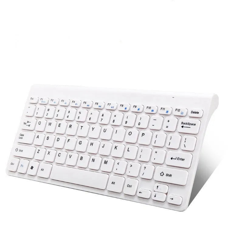 Black and white wireless keyboard and mouse set on a wooden desk