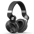 Black Bluetooth earbuds showing card plug-in storage design and separate silicone eartips.