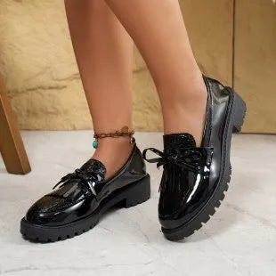 Women's brown loafer shoe with a decorative bow on the artificial PU upper.