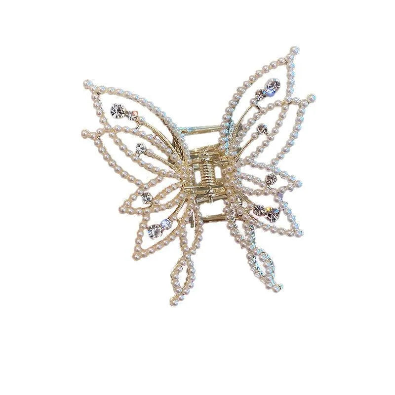 Butterfly-shaped alloy hair clip with electroplated finish in pearl or rhinestone style.
